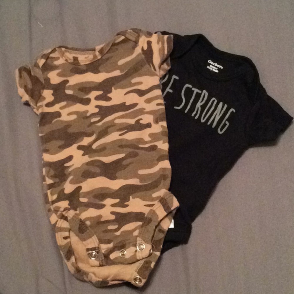 a army onesie and a be strong onesie